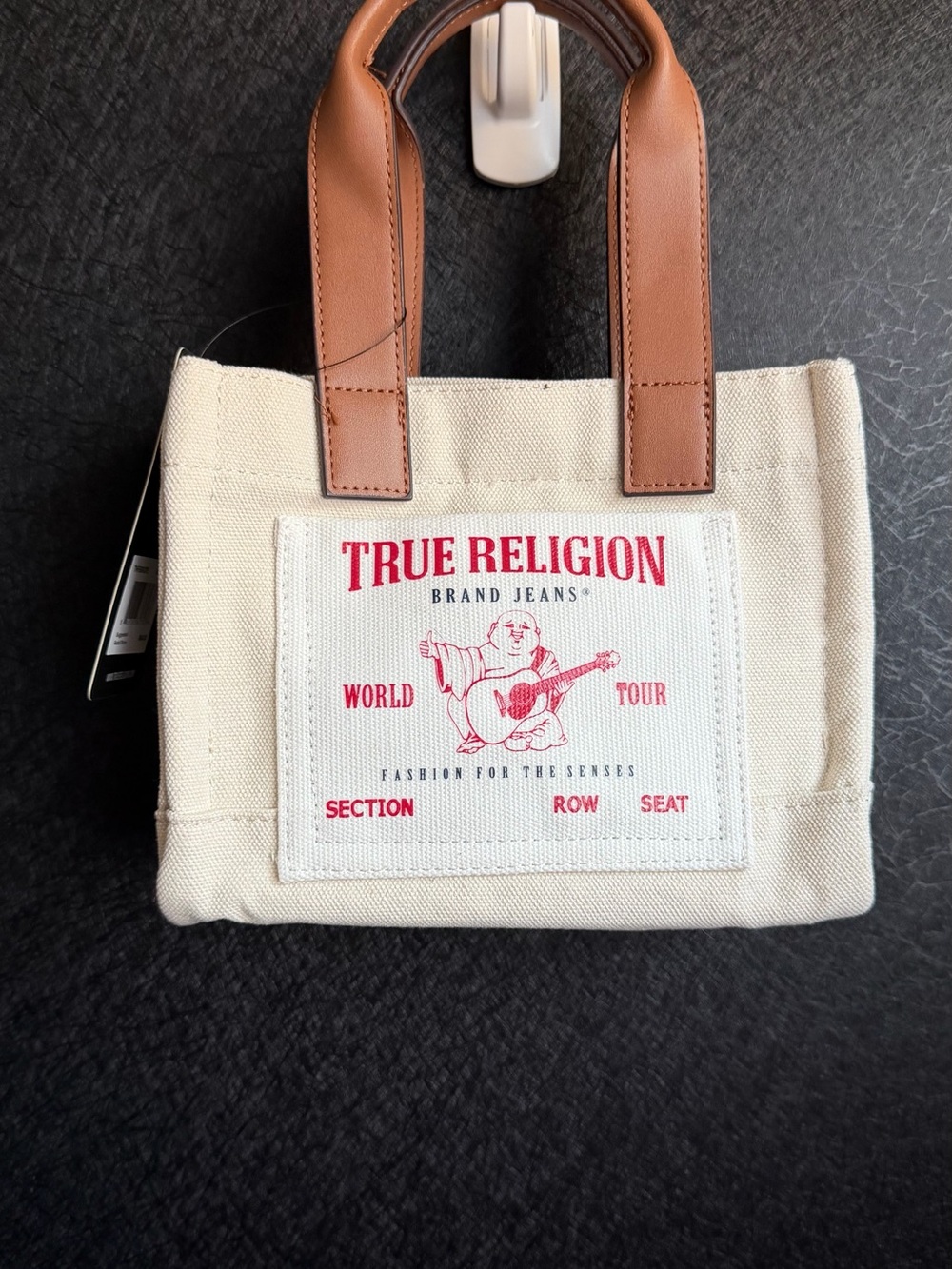 True Religion Cream Canvas Tote with Brown Leather Handles and Red Logo Patch